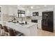 Stylish kitchen with white cabinets, stainless steel appliances, a breakfast bar, and modern backsplash at 2440 E Hale St, Mesa, AZ 85213