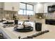 Close up of the white kitchen with black hardware and quartz countertop with decor at 2440 E Hale St, Mesa, AZ 85213