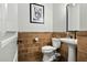 Well-lit powder bathroom with pedestal sink, modern toilet, and unique wall decorations at 2484 E Lodgepole Dr, Gilbert, AZ 85298