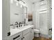 Modern bathroom with dual sinks, white cabinets, and shower/tub combo at 2484 E Lodgepole Dr, Gilbert, AZ 85298