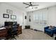 Well-lit bedroom with ceiling fan, neutral carpet, and home office setup at 2484 E Lodgepole Dr, Gilbert, AZ 85298