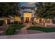 Charming home featuring a brick walkway leading to a grand entrance framed by lush greenery and manicured landscaping at 2484 E Lodgepole Dr, Gilbert, AZ 85298