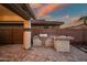 Covered outdoor kitchen with stone counter, built-in grill, and ample counter space at 2484 E Lodgepole Dr, Gilbert, AZ 85298