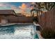 Backyard pool showcasing a water feature, mature landscaping, and privacy fence at 2484 E Lodgepole Dr, Gilbert, AZ 85298