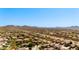 Expansive aerial view showcases a community set against a mountain range and desert landscape at 2525 W Sat Nam Way, Phoenix, AZ 85086