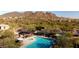 Aerial view of a community pool area with mountain views, showcasing a pool, spa, and lounge area at 2525 W Sat Nam Way, Phoenix, AZ 85086