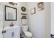 Well-lit half bath boasts stylish decor, a decorative mirror, and a modern vanity at 2525 W Sat Nam Way, Phoenix, AZ 85086