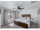 Comfortable bedroom featuring a large bed, window with blinds, and a decorative accent wall at 2525 W Sat Nam Way, Phoenix, AZ 85086