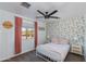 Bright bedroom featuring stylish floral wallpaper, a ceiling fan, and a cozy iron bed at 2525 W Sat Nam Way, Phoenix, AZ 85086