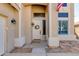 Close up of the front door with sidelight and decor wreath, showing stone accents and covered entry at 2525 W Sat Nam Way, Phoenix, AZ 85086