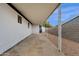 Spacious covered back patio with concrete flooring and gravel landscaping, offering outdoor living space at 2570 W Scenic St, Apache Junction, AZ 85120