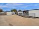 View of the backyard with a storage shed, concrete pad and easy access to home at 2570 W Scenic St, Apache Junction, AZ 85120