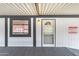 Covered entrance of a home with a storm door and a small window on the side at 2570 W Scenic St, Apache Junction, AZ 85120