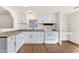 Modern kitchen with white cabinets and open shelving at 2570 W Scenic St, Apache Junction, AZ 85120