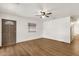 Bright living room with wood-look flooring, neutral paint, ceiling fan, and natural light at 2570 W Scenic St, Apache Junction, AZ 85120