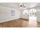 Open living room with wood-look floors, neutral paint, and an opening to the kitchen at 2570 W Scenic St, Apache Junction, AZ 85120