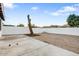 Spacious backyard featuring gravel, concrete patio and white block wall for privacy at 2834 N 65Th Ave, Phoenix, AZ 85035