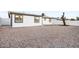 Expansive gravel backyard with white block fencing bordering the property for privacy at 2834 N 65Th Ave, Phoenix, AZ 85035