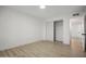 Bedroom with wood floors, sliding closet, and white walls, and a ceiling light at 2834 N 65Th Ave, Phoenix, AZ 85035