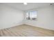 A bright bedroom featuring new light wood flooring and freshly painted white walls at 2834 N 65Th Ave, Phoenix, AZ 85035