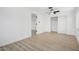 Bedroom featuring wood floors, closet, ceiling fan, and white walls at 2834 N 65Th Ave, Phoenix, AZ 85035