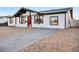 Charming single-story home featuring a red front door and gravel landscaping at 2834 N 65Th Ave, Phoenix, AZ 85035