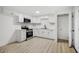 Modern kitchen with stainless steel appliances and white cabinets, with a black faucet at 2834 N 65Th Ave, Phoenix, AZ 85035