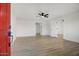 Spacious living room featuring new light wood flooring and freshly painted white walls at 2834 N 65Th Ave, Phoenix, AZ 85035