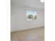 Bright living room featuring new wood floors, white walls, and a large window at 2834 N 65Th Ave, Phoenix, AZ 85035