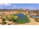 Scenic aerial view of the community featuring a pond and a golf course at 28793 N Spur Dr, San Tan Valley, AZ 85143