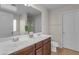 Bathroom featuring a double sink vanity, tile floors, and a large mirror at 28793 N Spur Dr, San Tan Valley, AZ 85143