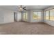 Large bedroom featuring carpet, a ceiling fan, and scenic views from dual windows at 28793 N Spur Dr, San Tan Valley, AZ 85143