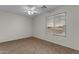 Bright bedroom with carpet, a ceiling fan, and a large window with blinds at 28793 N Spur Dr, San Tan Valley, AZ 85143