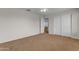 Carpeted bedroom with open door and mirrored closet doors at 28793 N Spur Dr, San Tan Valley, AZ 85143