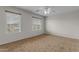 Bedroom featuring neutral walls, carpet, two windows, and a ceiling fan at 28793 N Spur Dr, San Tan Valley, AZ 85143