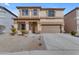 Charming two-story home with tan stucco, well-kept landscaping and a two car garage in a well-maintained neighborhood at 28793 N Spur Dr, San Tan Valley, AZ 85143