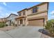 Exterior view of a stucco two-story house with a two-car garage and desert landscaping at 28793 N Spur Dr, San Tan Valley, AZ 85143