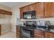 Close up on the kitchen area with black appliances and granite countertops at 28793 N Spur Dr, San Tan Valley, AZ 85143