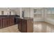 Kitchen island with wood cabinets and dark granite counters at 28793 N Spur Dr, San Tan Valley, AZ 85143