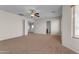 Upstairs living room with carpet, white walls, a ceiling fan and open doors at 28793 N Spur Dr, San Tan Valley, AZ 85143