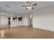 Open-concept living room with tile flooring, ceiling fan, and view to the kitchen at 28793 N Spur Dr, San Tan Valley, AZ 85143