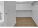 Walk-in closet with a toilet, carpet floors and built in shelving at 28793 N Spur Dr, San Tan Valley, AZ 85143