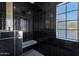 Modern shower featuring black tile, a shower bench, and a window for natural lighting at 2964 E Palo Verde St, Gilbert, AZ 85296