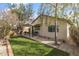 Backyard with green turf, patio seating, and mature trees, perfect for outdoor enjoyment at 3018 W Matthew Dr, Phoenix, AZ 85027