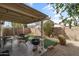 Cozy backyard with covered patio, seating area, barbecue, and manicured landscaping at 3018 W Matthew Dr, Phoenix, AZ 85027