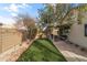 Spacious backyard featuring turf, covered patio, barbecue, and privacy fencing at 3018 W Matthew Dr, Phoenix, AZ 85027