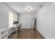 Bright bedroom with wood floors, a desk area, and natural light from a large window at 3018 W Matthew Dr, Phoenix, AZ 85027