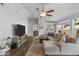 Cozy living room with wood flooring, a ceiling fan, and plenty of natural light at 3018 W Matthew Dr, Phoenix, AZ 85027