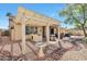 Inviting backyard with a covered patio, built-in grill, bird bath, and desert landscaping, perfect for outdoor entertaining at 3032 N 160Th Ave, Goodyear, AZ 85395