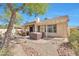 Relaxing backyard featuring a covered patio, hot tub, desert landscaping, offering a tranquil outdoor experience at 3032 N 160Th Ave, Goodyear, AZ 85395